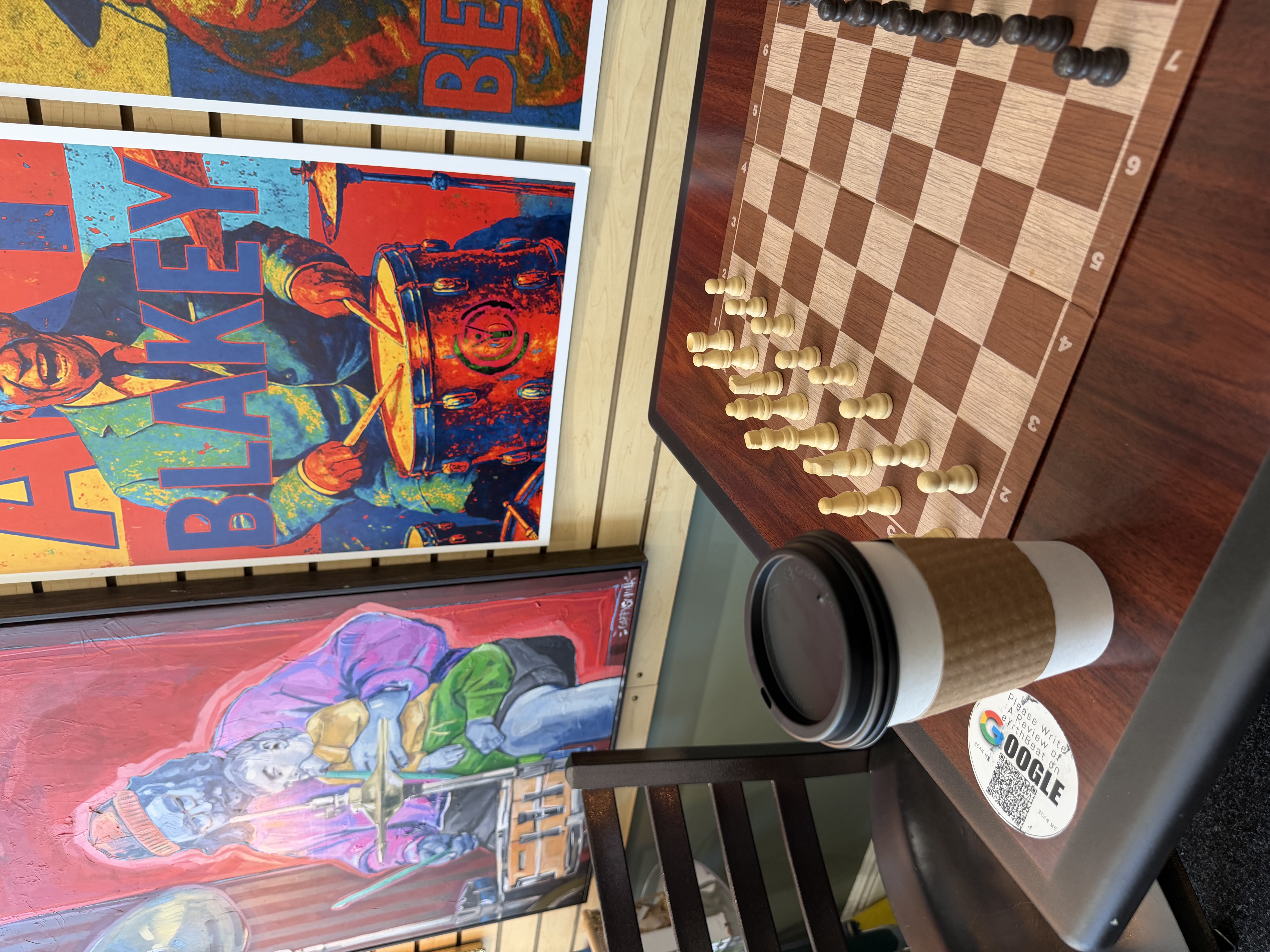 A chess table and colorful art inside eYrthBeat
